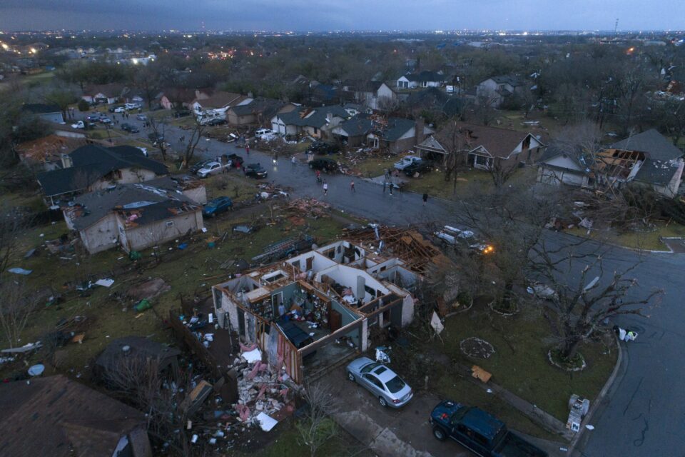 Some residents survived the tornado by sheltering in a freezer. Storms uprooted homes and trees. At least 24 people are dead and dozens are missing.